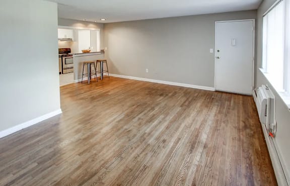 a living room and kitchen with a wooden floor  at Greenfield Village Apartments, Rocky Hill, CT