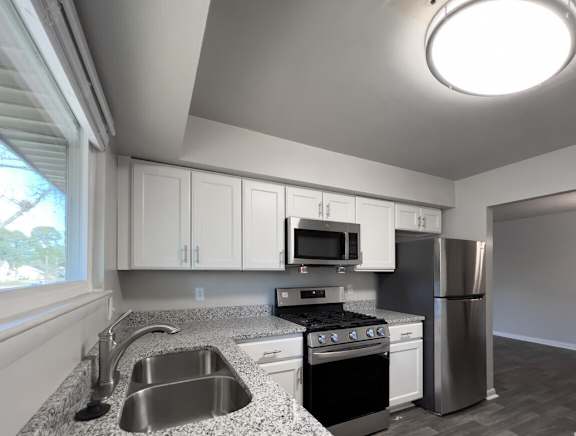 a kitchen with granite counter tops and stainless steel appliances