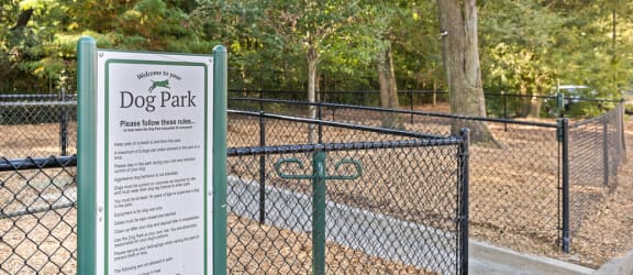 a dog park with a sign in front of it