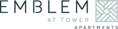 A sign that says "EMBLEM AT TOWER APARTMENTS" with a graphic of a building.