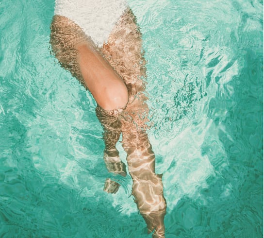 A woman's legs in a swimming pool.