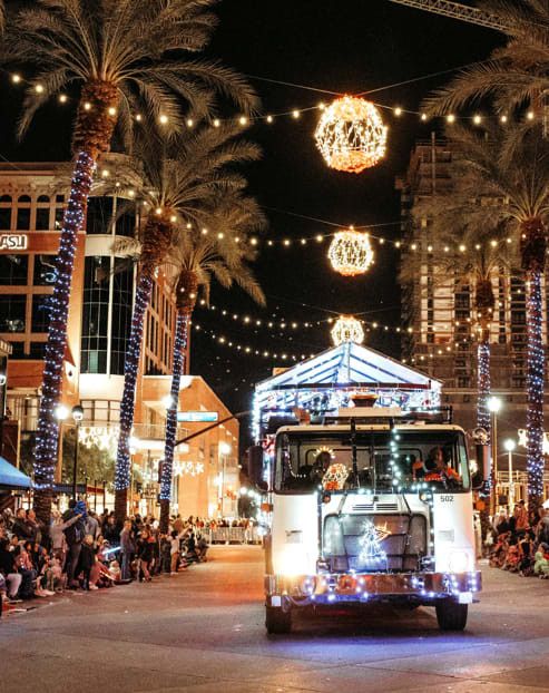 a food truck drives down the street in front of a crowd of people  at Sofia Apartments, Tempe, AZ, 85283