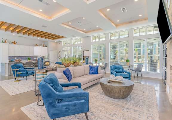 A living room with blue chairs and a white couch.
