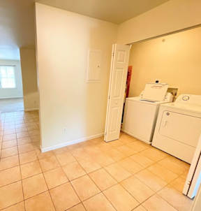 A kitchen area with a white fridge and a white door.