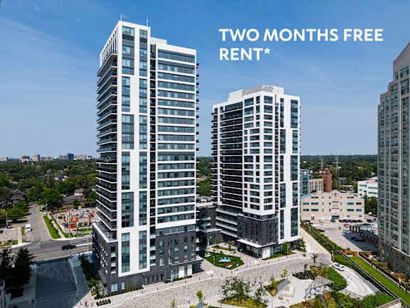 Two tall buildings with a sign that says "Two Months Free Rent".