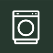 a white icon of a washing machine on a green background