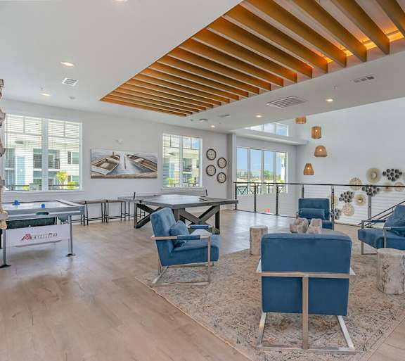 A living room with a blue sofa and chairs.
