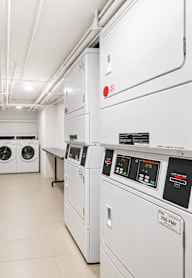A laundry room with washers and dryers.