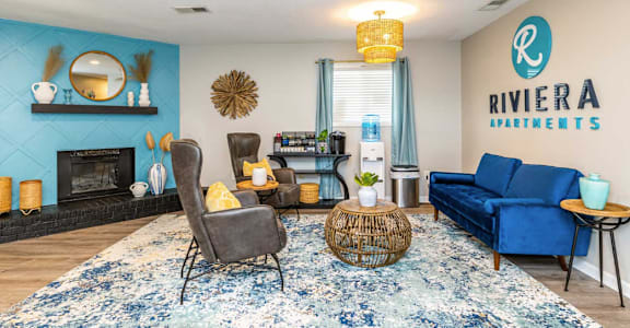 A living room with a fireplace and a blue couch.