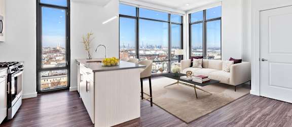 a kitchen and living room with a view of a city