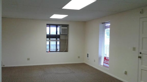 an empty room with a window and a door