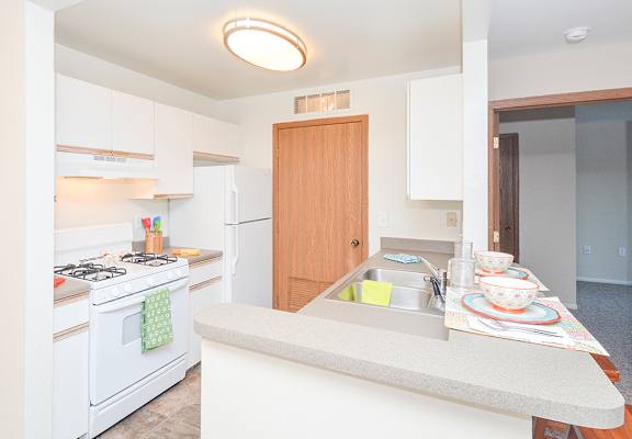 Kitchen with White Appliances and Breakfast Bar