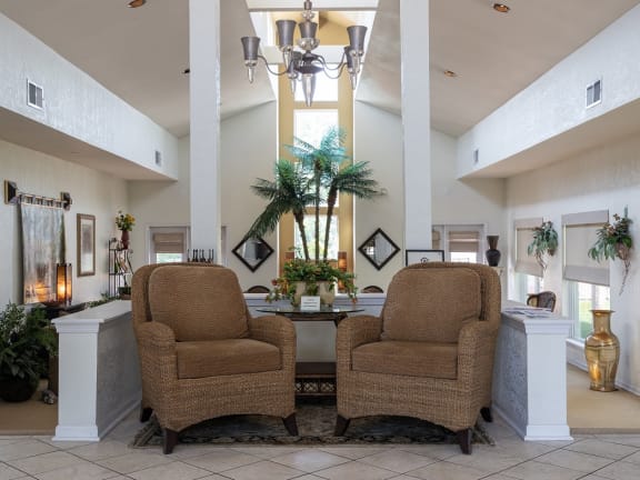 A cozy clubhouse living room with plush seating and a fireplace.