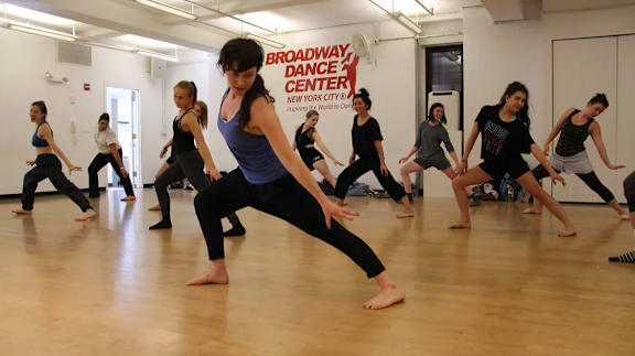 a group of women dancing in a dance studio