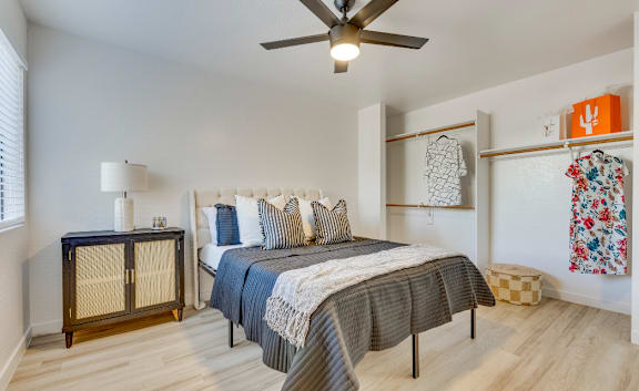 a bedroom with a bed and a ceiling fan