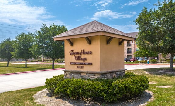 A small building with a sign that says "Garden Home" on it.