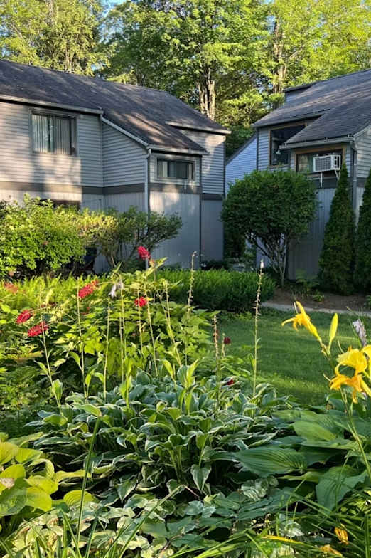 A small pool in a backyard with a house in the background.