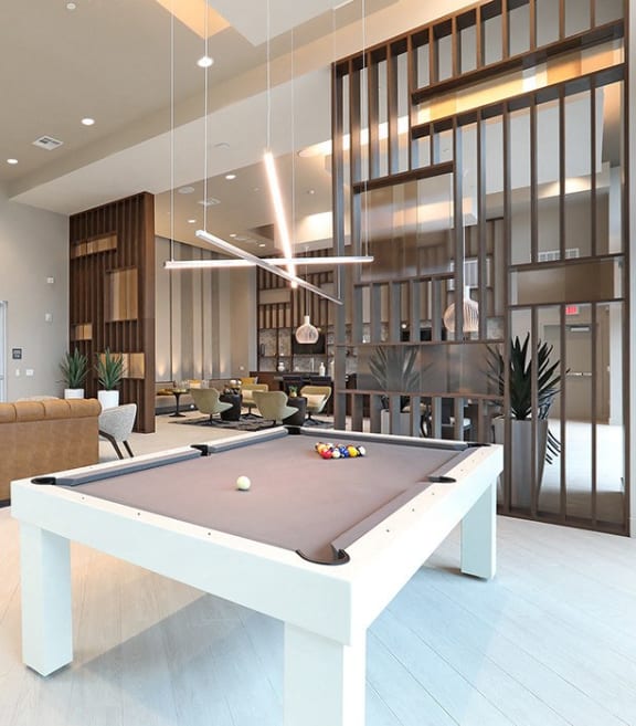 a living room with a pool table and a couch
