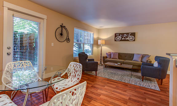 A living room with a glass table and chairs at Commons at Sylvan Highlands Apartments, Oregon, 97225