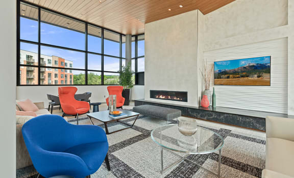 a living room with a fireplace and large windows