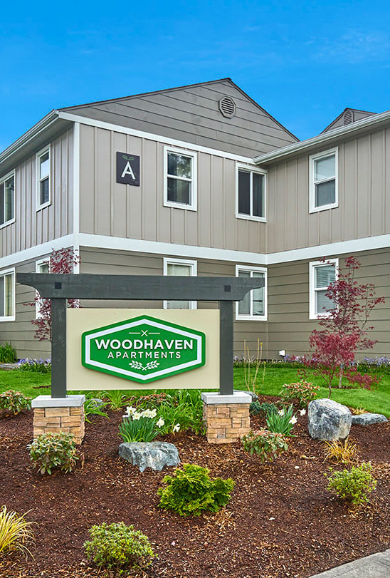 Woodhaven entrance sign surrounded with plant landscape