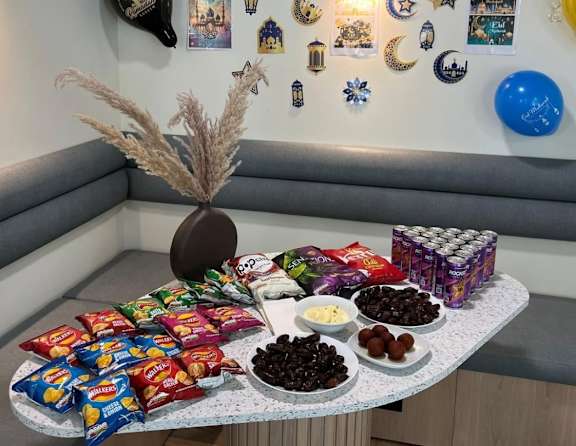 A table filled with snacks and a potted plant.