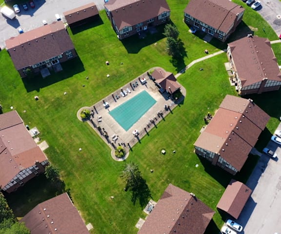 an aerial view of a neighborhood with houses and a swimming pool