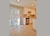 Thumbnail 8 of 33 - Dining room and kitchen view with sliding glass door to private patio