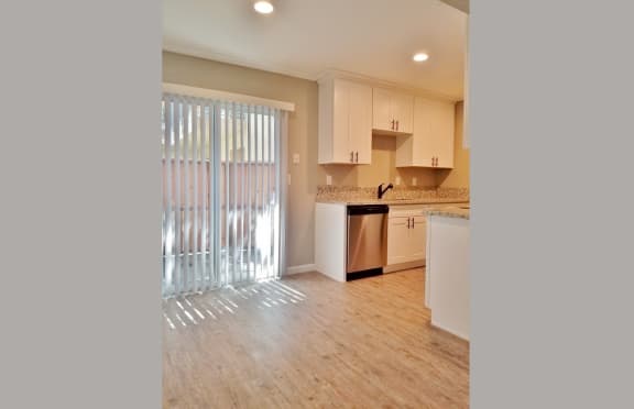 Dining room and kitchen view with sliding glass door to private patio