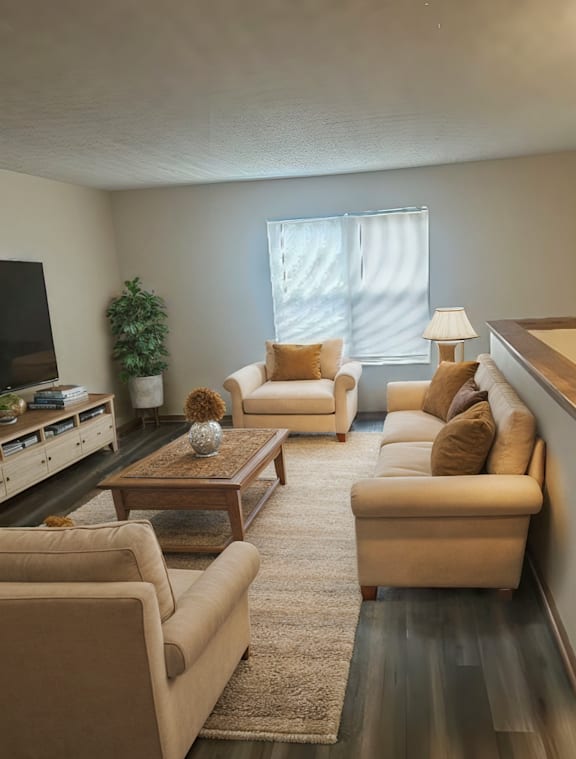 A living room with a couch, chair, and coffee table.