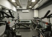Thumbnail 3 of 8 - a gym with various bikes and weights in it