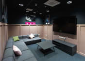 Thumbnail 1 of 8 - a living room with a couch and a television