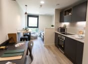 Thumbnail 2 of 8 - a kitchen and dining area in a small apartment