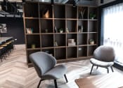 Thumbnail 7 of 8 - a room with two chairs and a table and a bookshelf