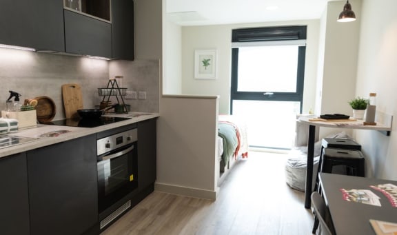 a small kitchen with a stove and a table