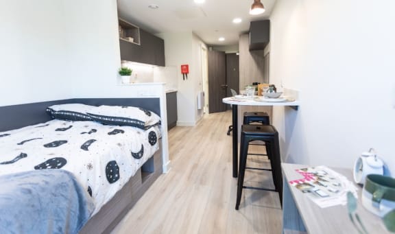 a bed and a kitchen in a small room