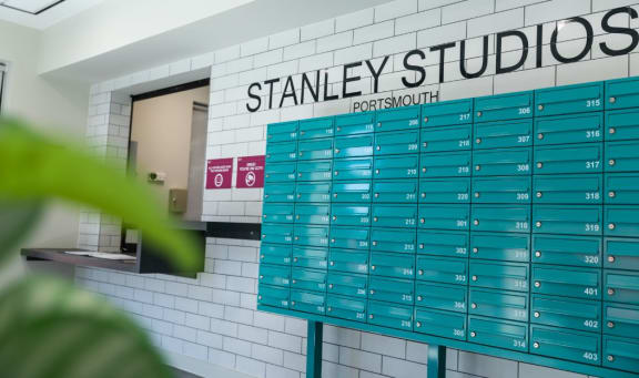 a view of the stanley studios restroom with the blue and white subway tiles