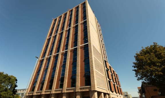a tall building with a blue sky in the background