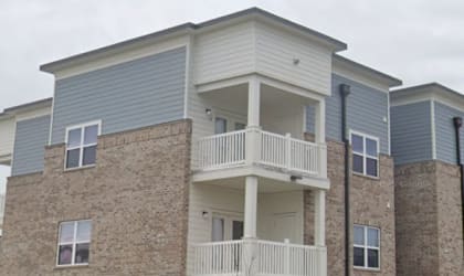A large two-story building with a balcony on the second floor.