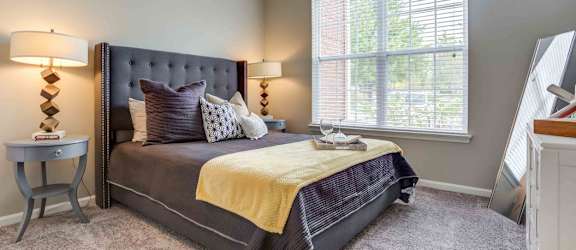 a bedroom with a bed and a window