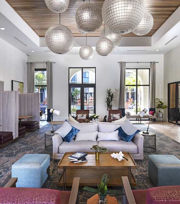 A modern living room with a grey sofa and a wooden coffee table.