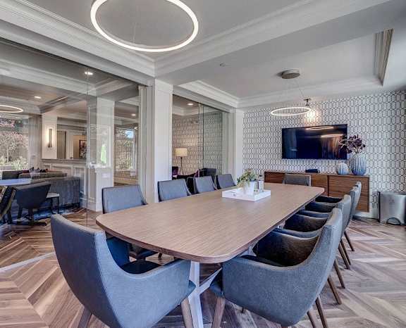 a conference room with a long wooden table and chairs