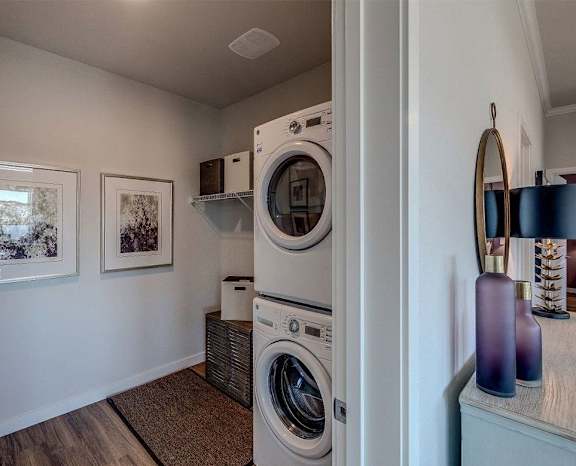 a laundry room with a washer and dryer and a window