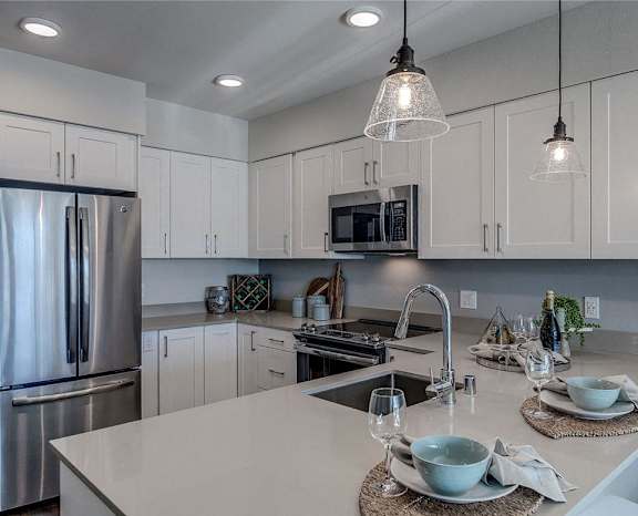 a kitchen with white cabinets and stainless steel appliances