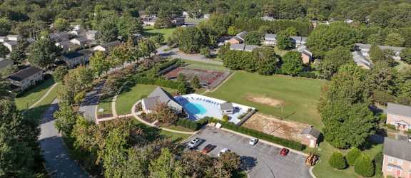 an aerial view of a house with a pool in the middle of the yard