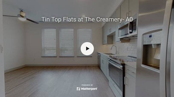 A kitchen with a video player overlay titled "Tin Top Flats at The Creamery- A0".