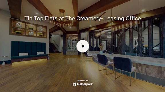 A video thumbnail showing a spacious room with wooden floors and a staircase.