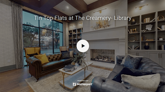A living room with a fireplace and a bookshelf.