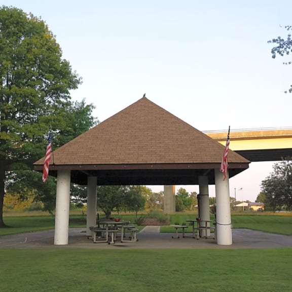 a pavilion with picnic tables in a park