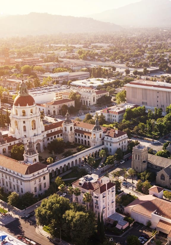 A cityscape with a prominent white building with a dome in the center.